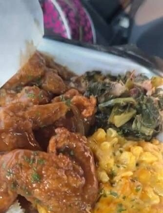 Saucy chicken wings plated with collard greens and baked macaroni and cheese